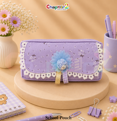 pencil pouch with floral lace trim and flower accent shown upright on a display podium with cute stationery items surrounding it