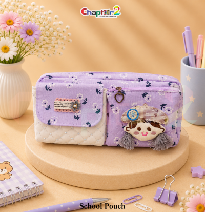 pencil pouch with cute girl doll and floral patchwork design shown upright on a display podium with cute stationery items surrounding it