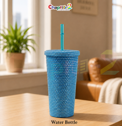water bottle featuring bling rhinestone blue tumbler design shown upright on a wooden table with a cozy background